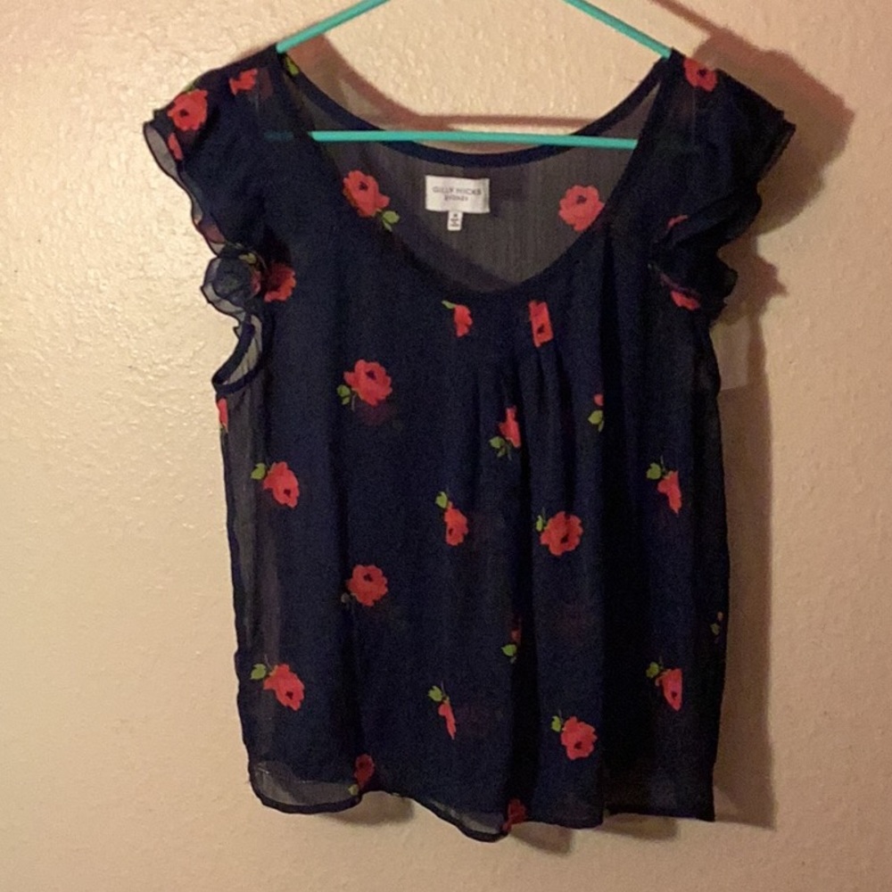 Gilly Hicks navy blue sheer talk top with floral accent and ruffled shoulders